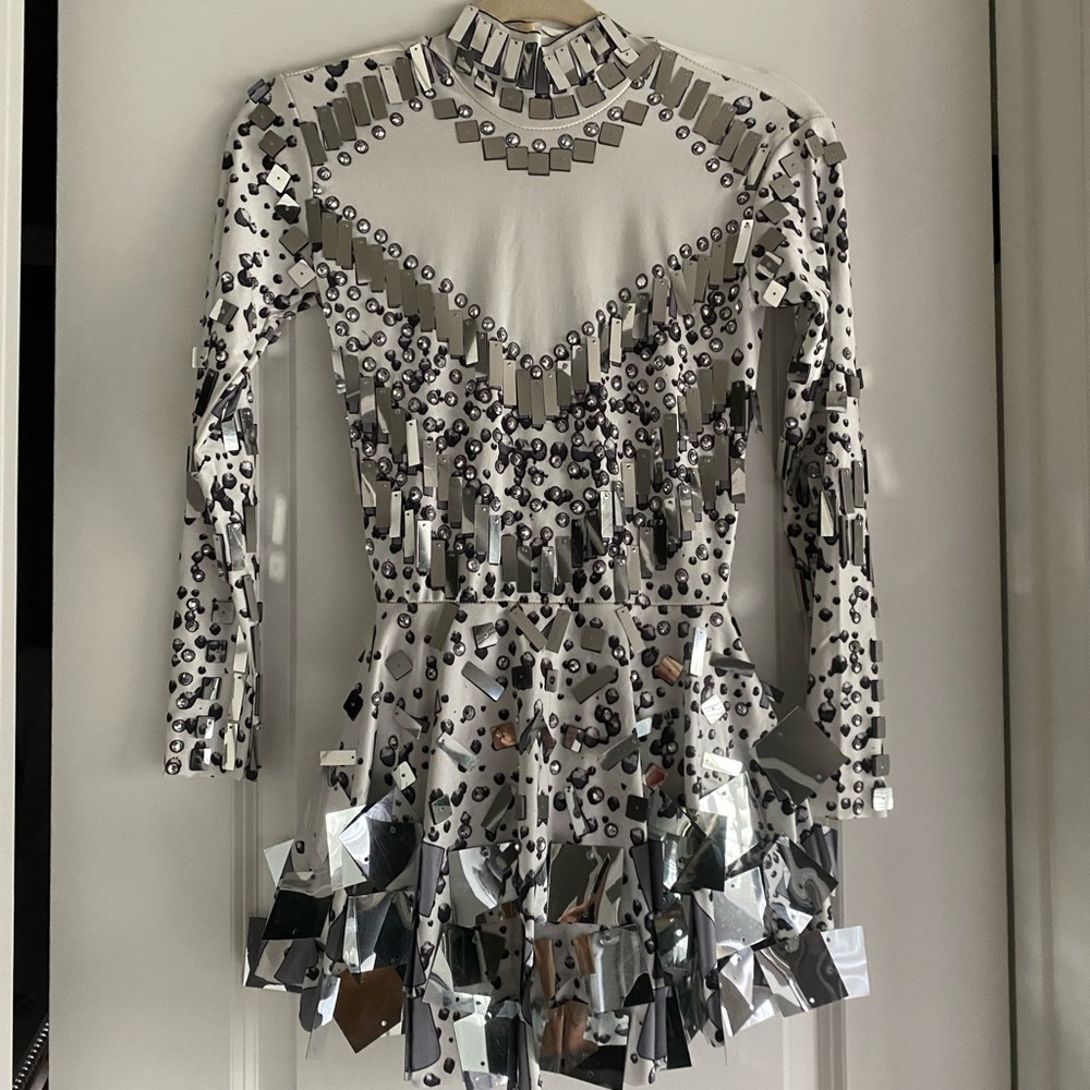 Skater style costume, white with silver accents and sequins. Size small